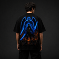 Person wearing a black t-shirt with a blue and orange graphic design on the back against a dark background