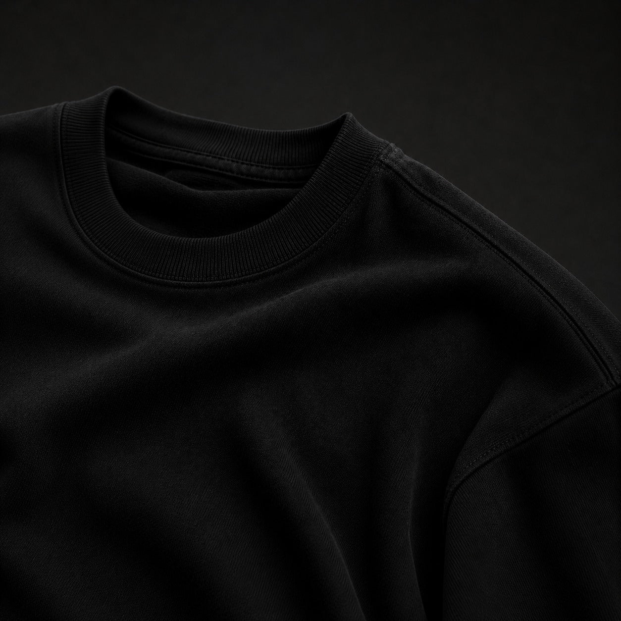 Close-up of a black sweatshirt against a dark background