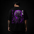 Person wearing a black t-shirt with a purple and white graphic design on the back against a black background