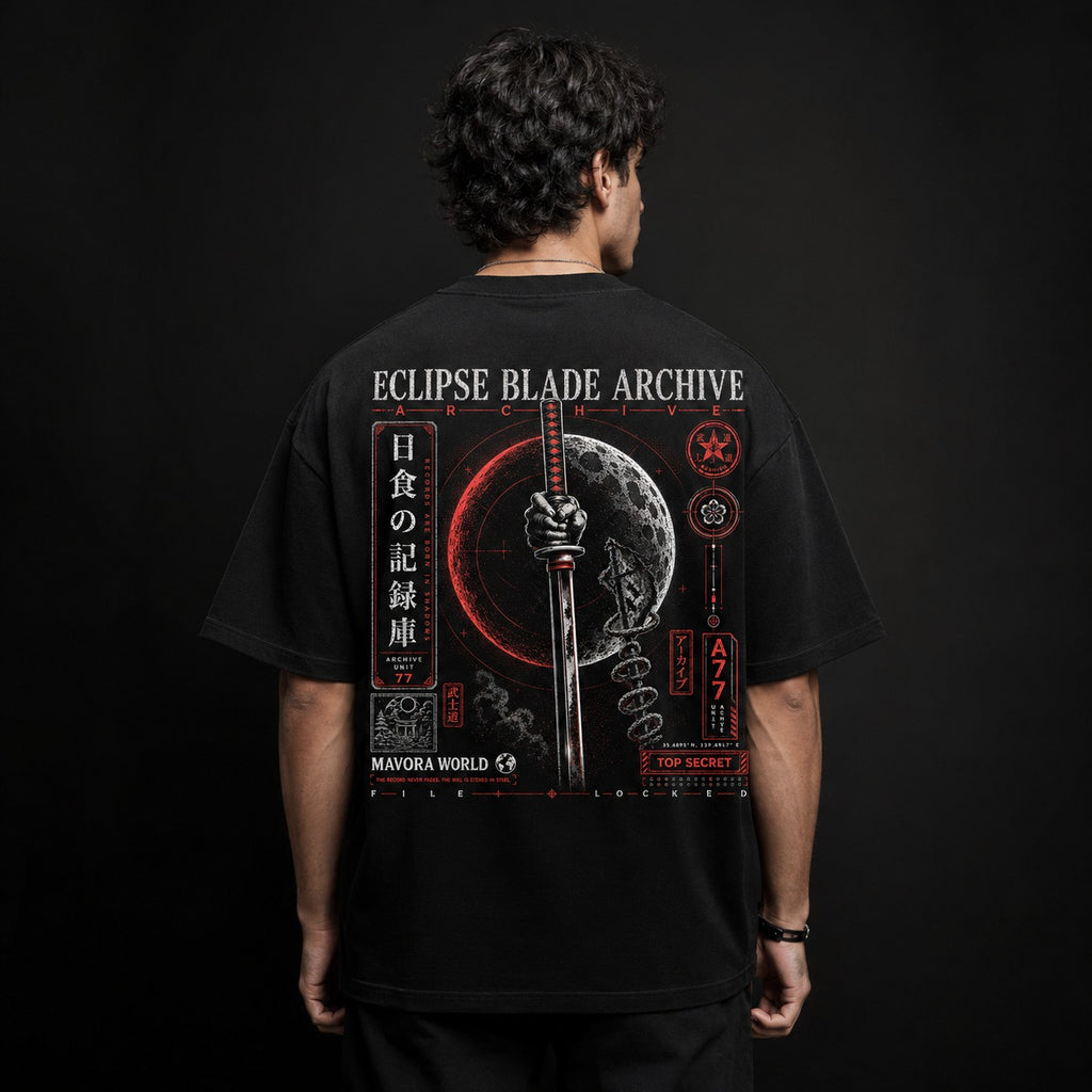 Person wearing a black t-shirt with 'Eclipse Blade Archive' design on the back against a dark background