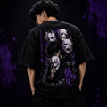 Person wearing a black t-shirt with graphic designs and text on the back against a dark background.