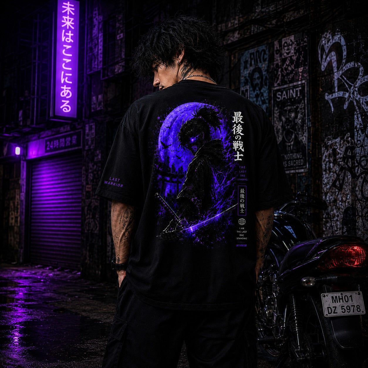 Person wearing a black t-shirt with a blue graphic design in a dark, urban setting.