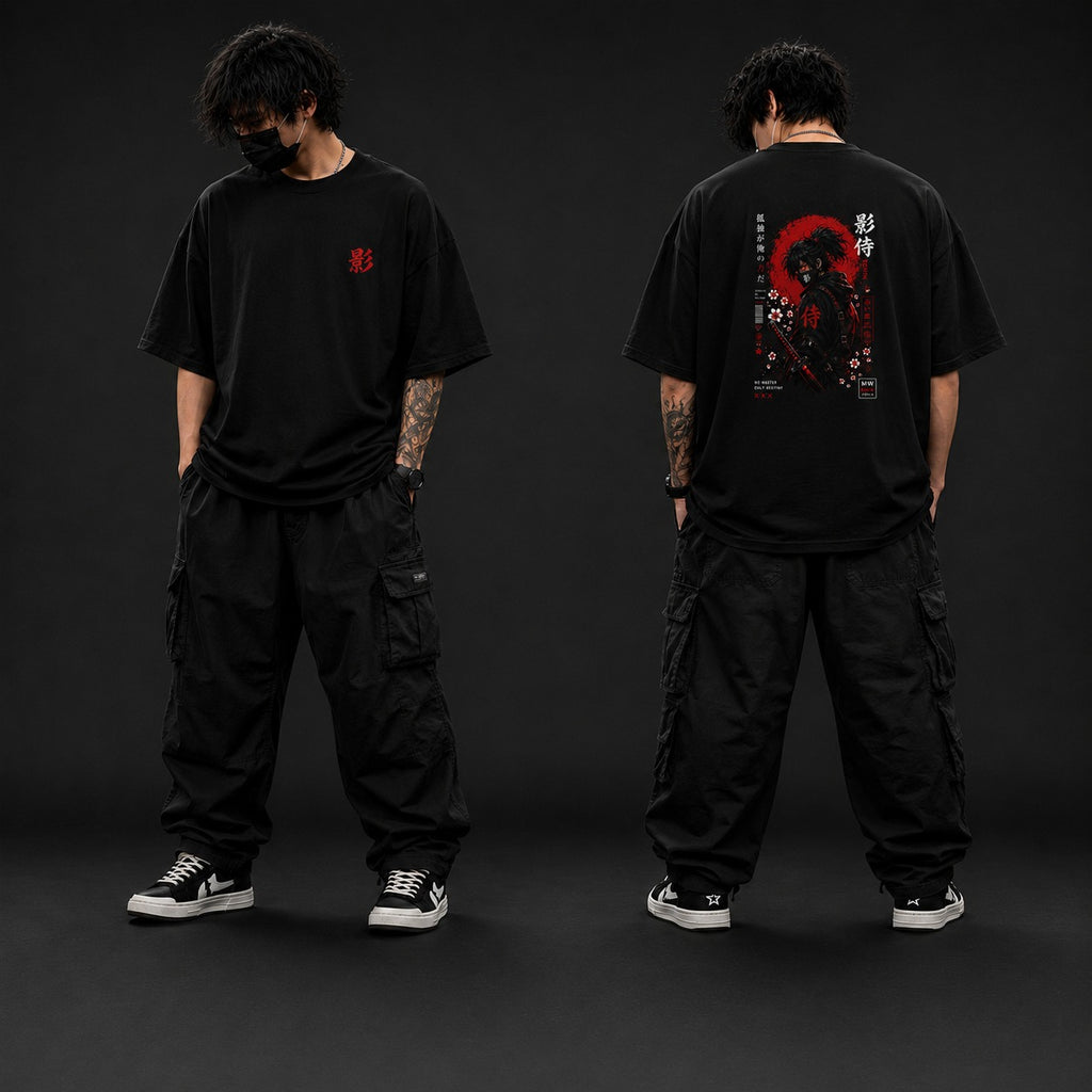 Person wearing a black t-shirt with a design on the front and back, standing against a dark background.