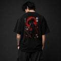 Person wearing a black t-shirt with a red and black design on the back against a dark background