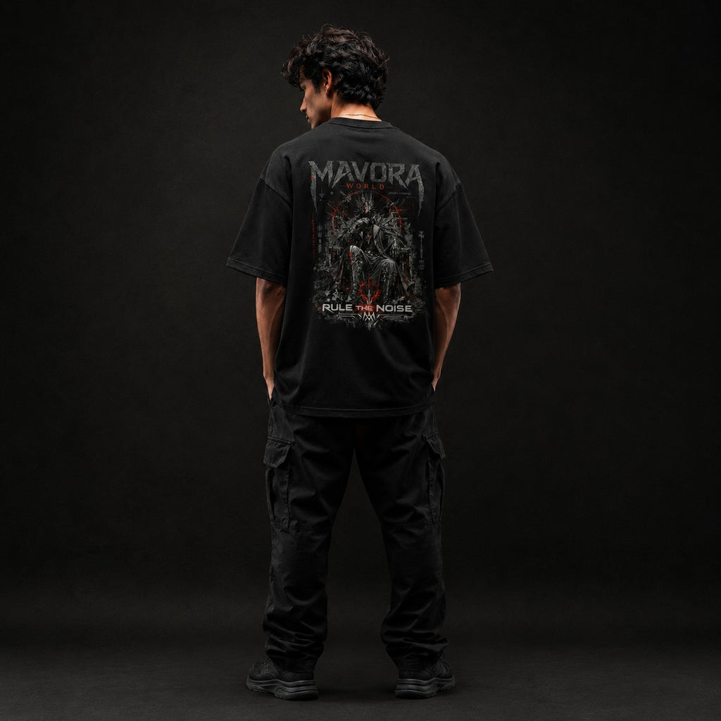 Person wearing a black t-shirt with 'Mavora' branding on the back against a dark background