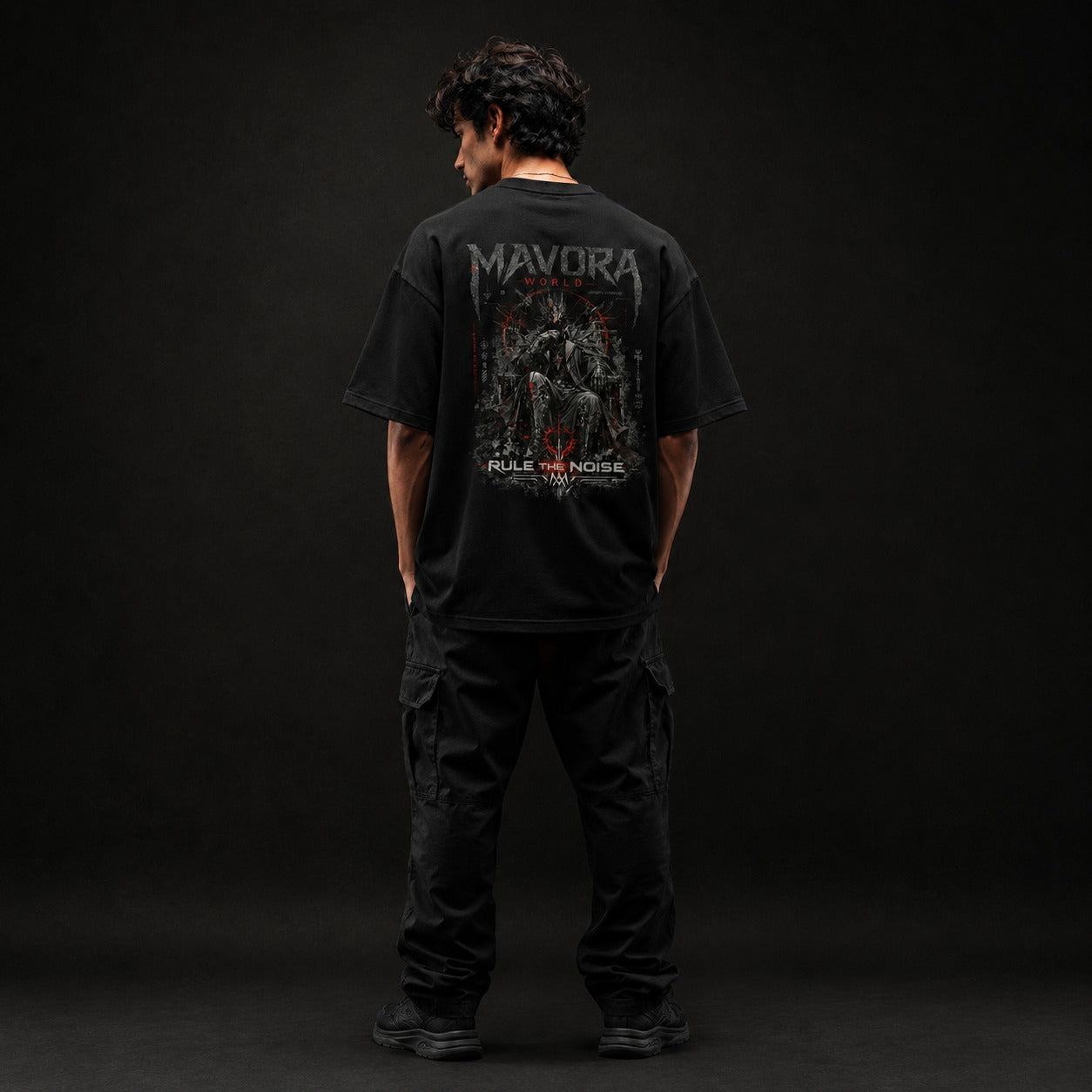 Person wearing a black t-shirt with 'Mavora' branding on the back against a dark background