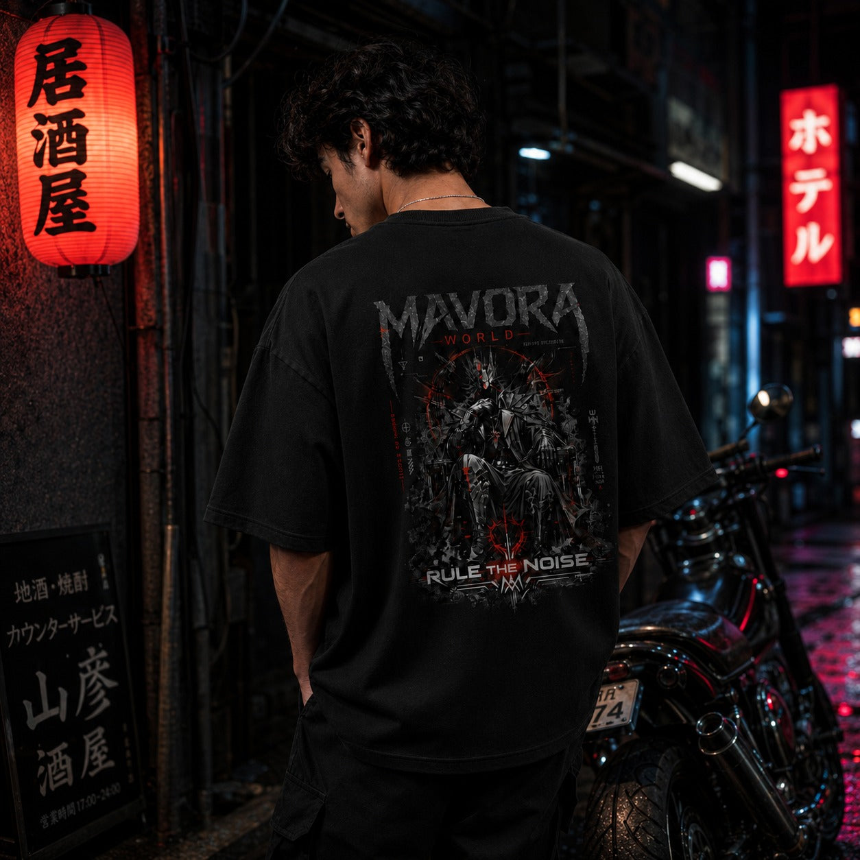 Person wearing a black t-shirt with 'MAVORA' design in an urban setting with neon signs.