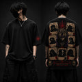 Person wearing a black t-shirt with intricate designs on the front and back against a dark background