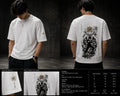 White t-shirt with black graphic design on a dark background