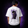 Person wearing a white t-shirt with a graphic design on the back against a dark purple background