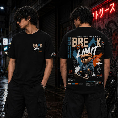 Two models wearing a black graphic t-shirt in a dark urban street setting at night. The front view shows a small 'BREAK THE LIMIT' graphic on the chest, while the back view reveals a large, detailed graphic featuring a cartoon bear in a blue hoodie and the text 'BREAK THE LIMIT' in white, orange, and blue.
