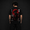 A man viewed from behind wearing a black short-sleeve T-shirt with a large red, black, and white samurai graphic print on the back, paired with black cargo pants against a dark studio background.